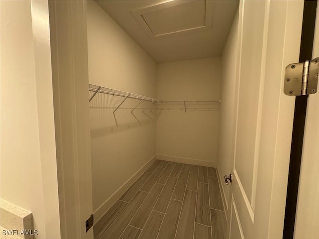 walk in closet with attic access and wood tiled floor