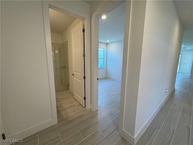 hall featuring wood finish floors and baseboards