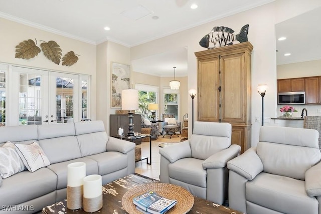 living room featuring french doors, light hardwood / wood-style floors, and ornamental molding