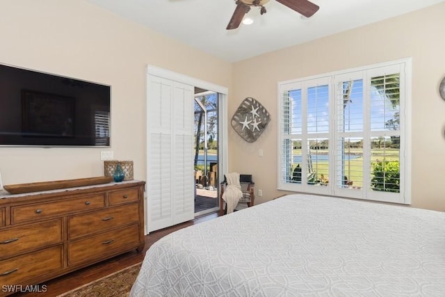 bedroom featuring access to outside, ceiling fan, and dark wood-type flooring