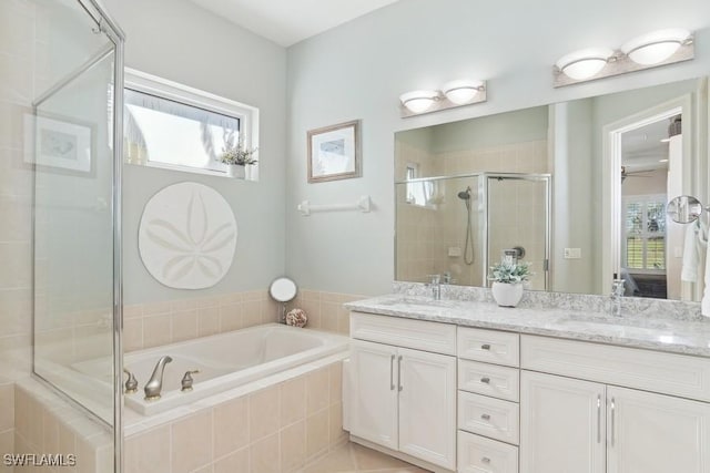 bathroom featuring tile patterned flooring, vanity, and shower with separate bathtub