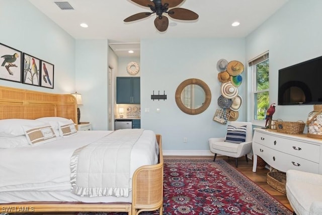 bedroom with dark hardwood / wood-style flooring and ceiling fan