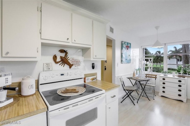 kitchen with visible vents, light wood-type flooring, light countertops, white range with electric stovetop, and white cabinets