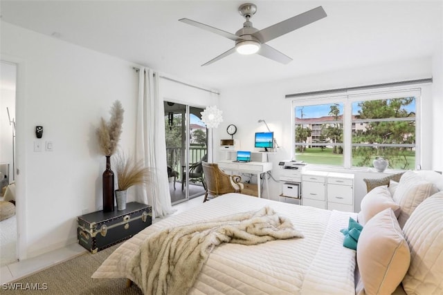 bedroom featuring access to exterior and a ceiling fan