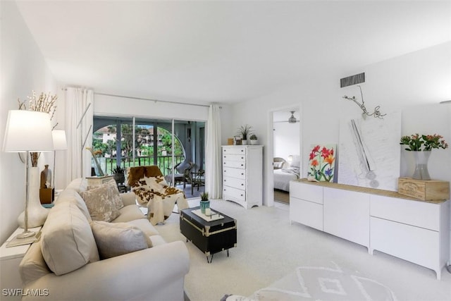 living room with visible vents and light carpet