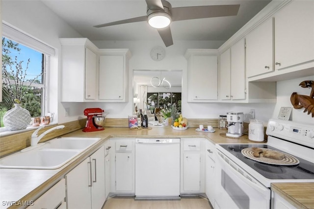 kitchen featuring white cabinetry, white appliances, light countertops, and a sink