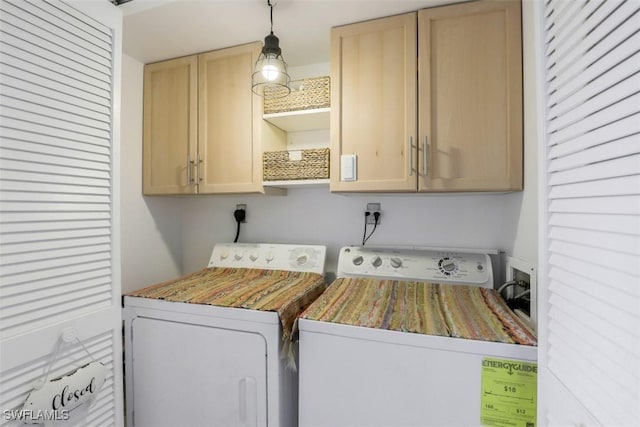 washroom featuring cabinet space and independent washer and dryer