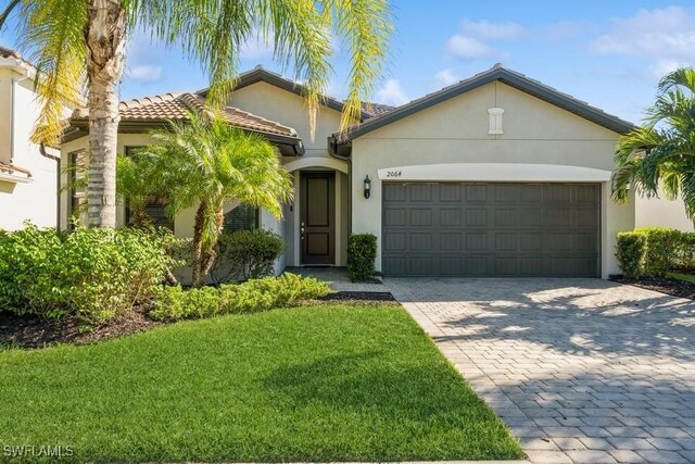 view of front of house featuring a front yard and a garage