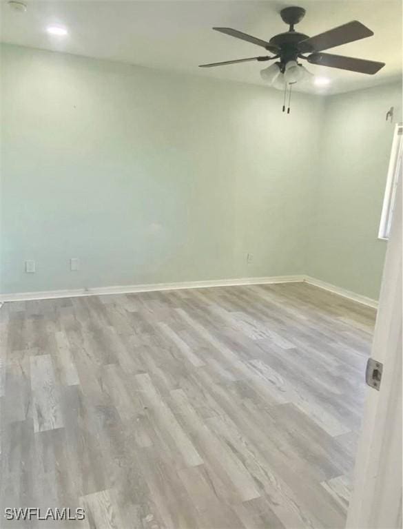 spare room featuring light hardwood / wood-style flooring and ceiling fan