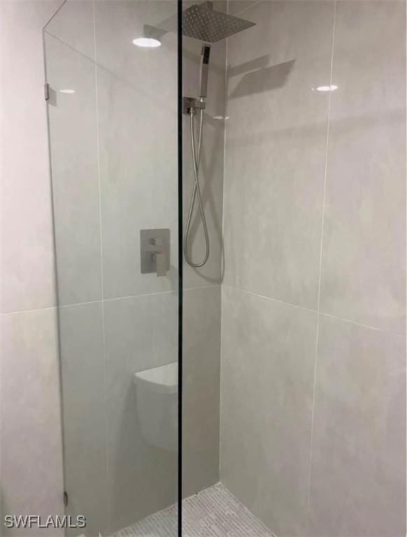 bathroom with tiled shower