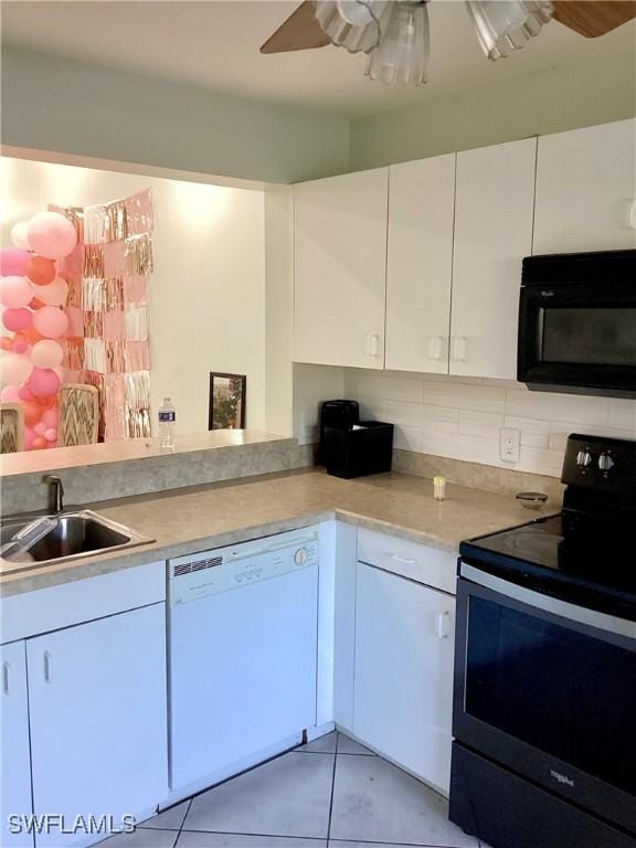 kitchen featuring black appliances, white cabinets, sink, light tile patterned floors, and tasteful backsplash