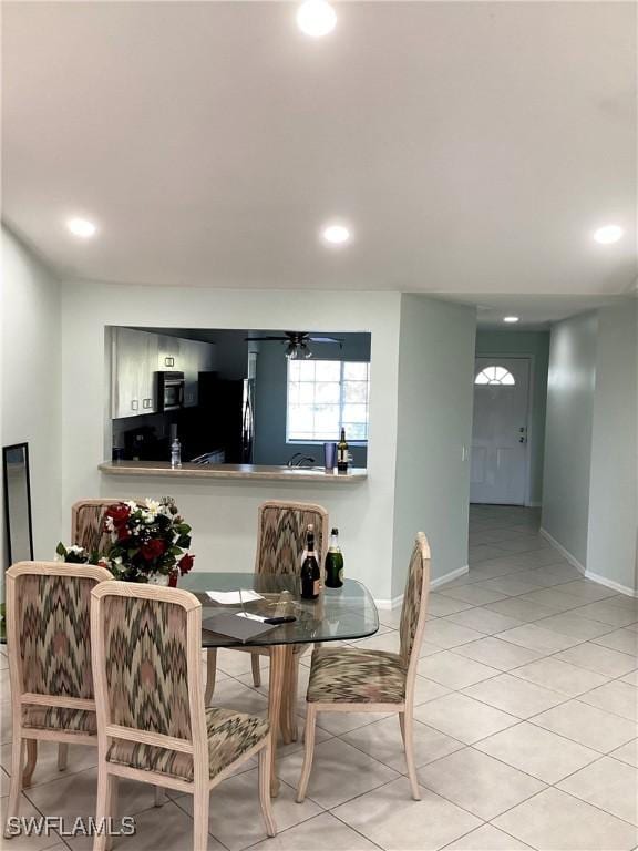 dining area featuring light tile patterned flooring