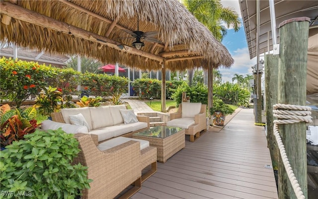 wooden terrace featuring a gazebo, an outdoor living space, and ceiling fan