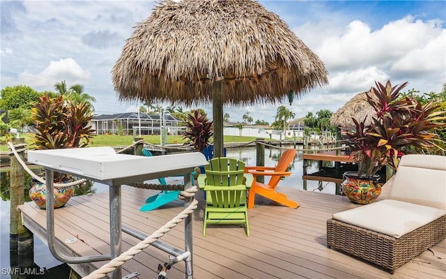 wooden deck with a boat dock and a water view