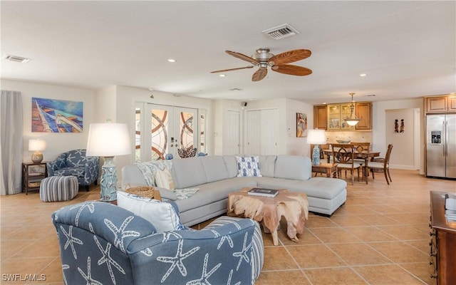 living room featuring light tile patterned floors and ceiling fan