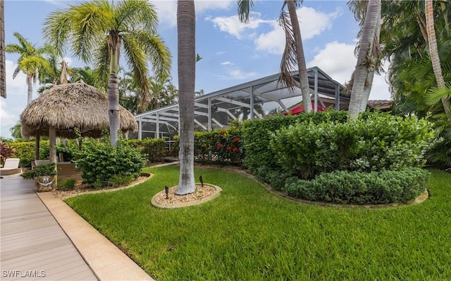 view of yard with a gazebo and glass enclosure