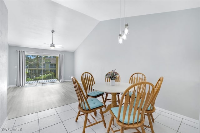 dining area featuring ceiling fan, light wood-type flooring, and vaulted ceiling