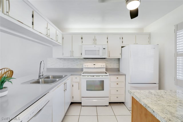 kitchen featuring white cabinetry, sink, tasteful backsplash, white appliances, and light tile patterned floors