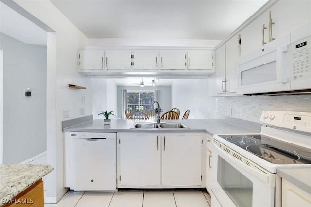 kitchen featuring white cabinets, white appliances, light tile patterned flooring, and sink