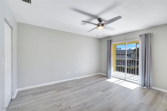 empty room featuring ceiling fan and light hardwood / wood-style flooring