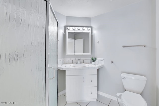 bathroom with tile patterned floors, vanity, toilet, and a shower with shower door