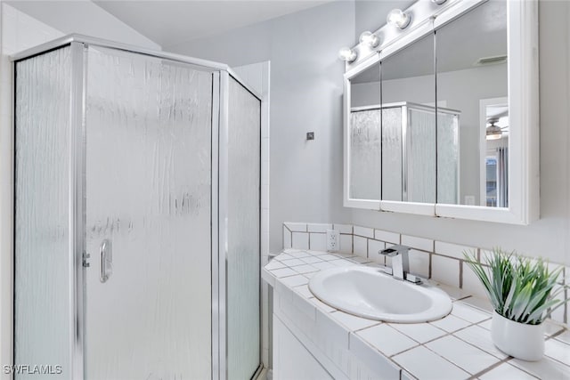 bathroom with vanity and a shower with shower door