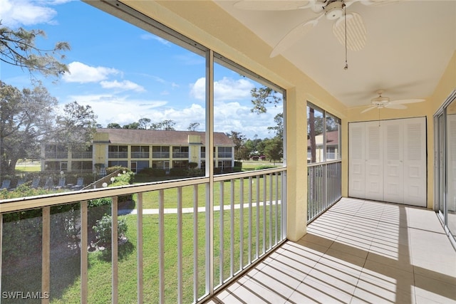 unfurnished sunroom featuring ceiling fan