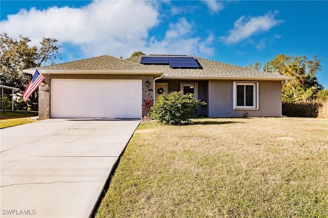 single story home featuring a garage, a front yard, and solar panels