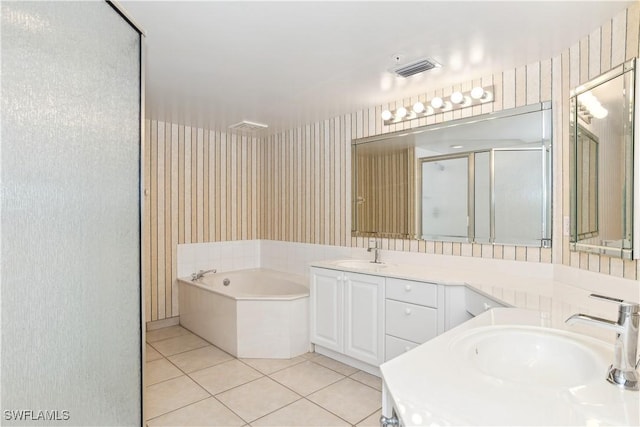 bathroom featuring shower with separate bathtub, vanity, and tile patterned floors