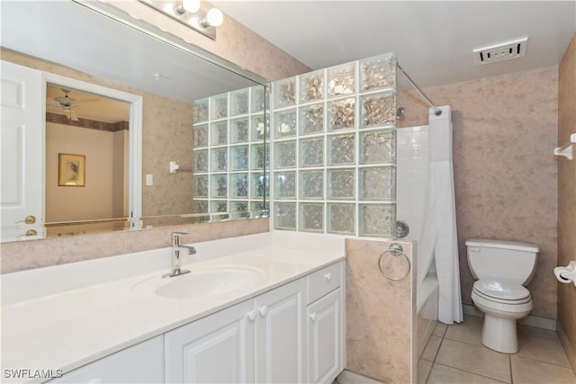 full bathroom with vanity, tile patterned floors, ceiling fan, toilet, and shower / bath combo with shower curtain