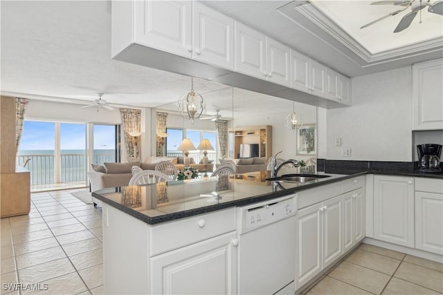 kitchen featuring kitchen peninsula, white dishwasher, crown molding, sink, and white cabinetry