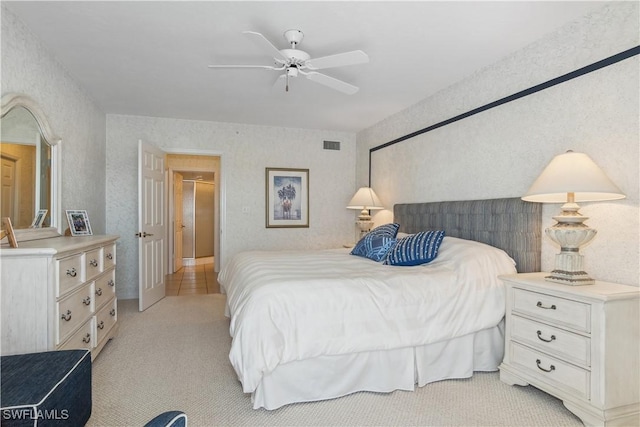 bedroom featuring ceiling fan and light carpet