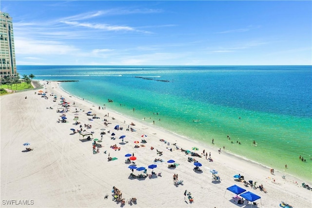 aerial view featuring a view of the beach and a water view