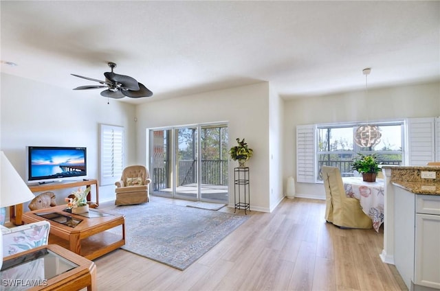 10041 Lake Cove Dr Unit 202, Fort Myers, FL 33908 - living room with light wood finished floors, a ceiling fan, and baseboards