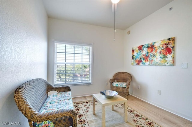 sitting room featuring hardwood / wood-style flooring and ceiling fan