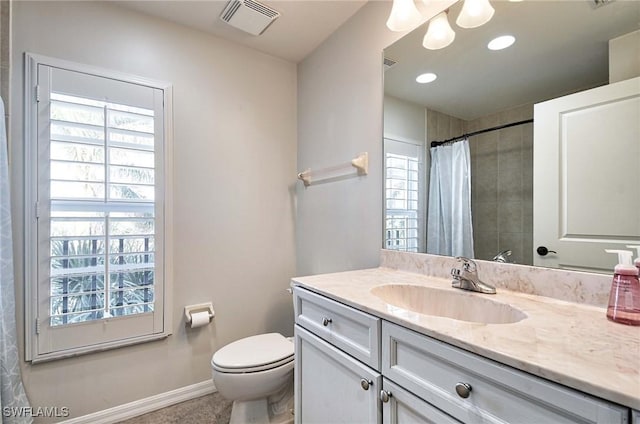 bathroom featuring tile patterned floors, vanity, toilet, and walk in shower