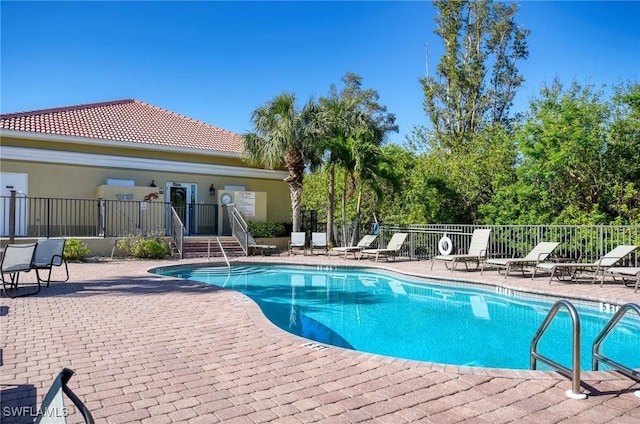 view of swimming pool with a patio