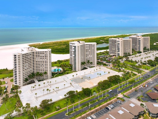 drone / aerial view with a water view and a beach view