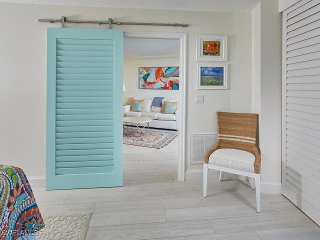 interior space with a barn door and light wood-type flooring