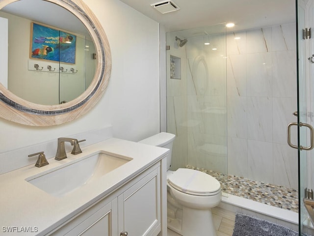 bathroom with tile patterned flooring, vanity, toilet, and a shower with shower door