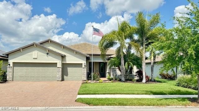 view of front of house with a front yard and a garage