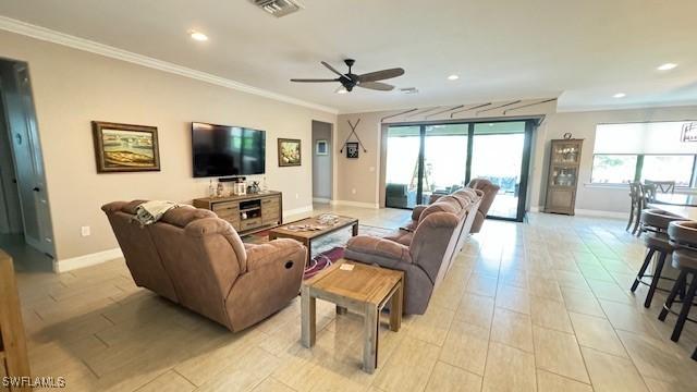 living room with ceiling fan and ornamental molding