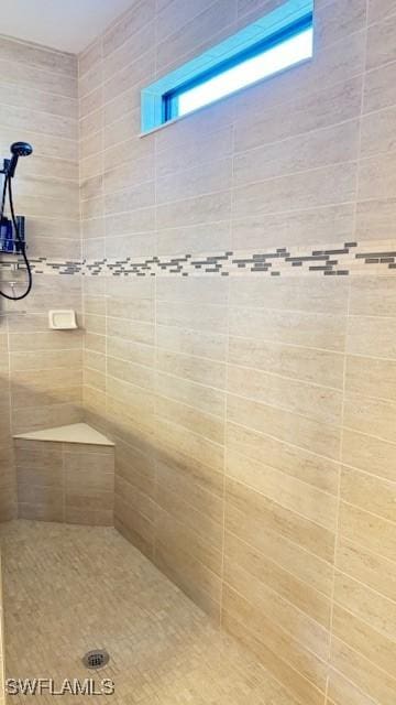 bathroom with a tile shower