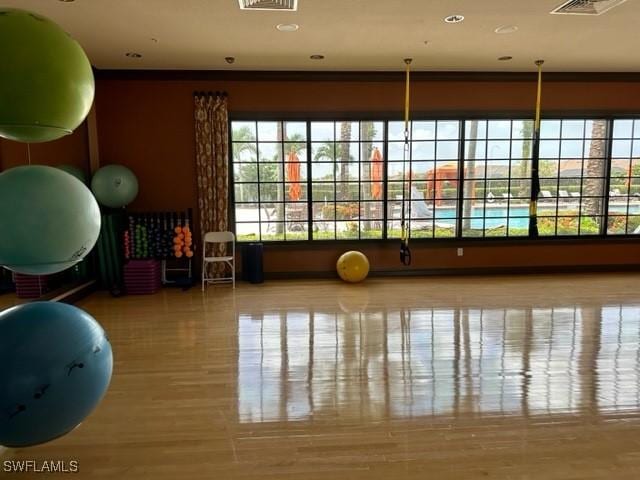 workout room with crown molding