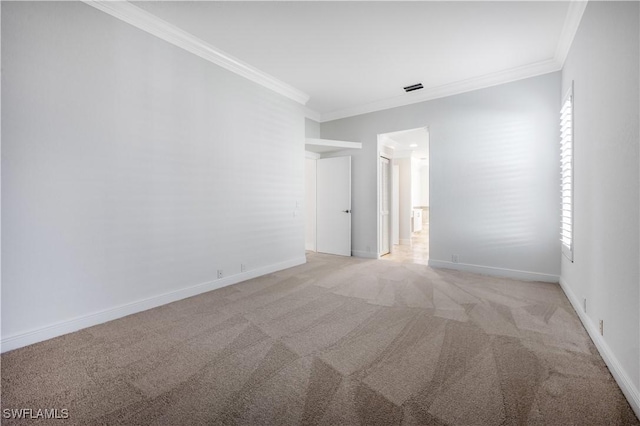 carpeted spare room featuring ornamental molding