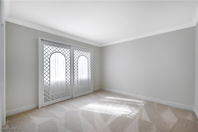 entryway with light carpet and ornamental molding