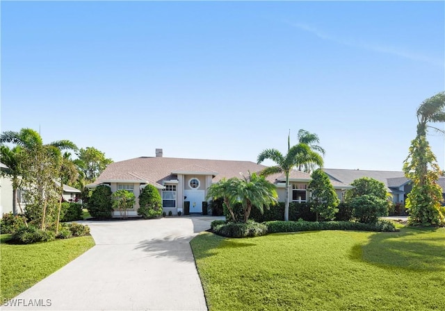 single story home with a front lawn