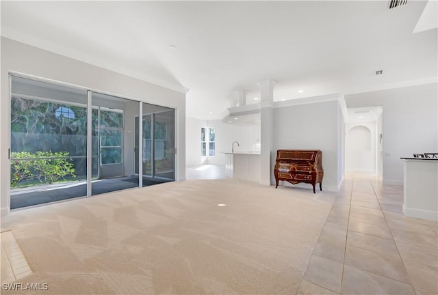 carpeted spare room featuring a wealth of natural light and crown molding