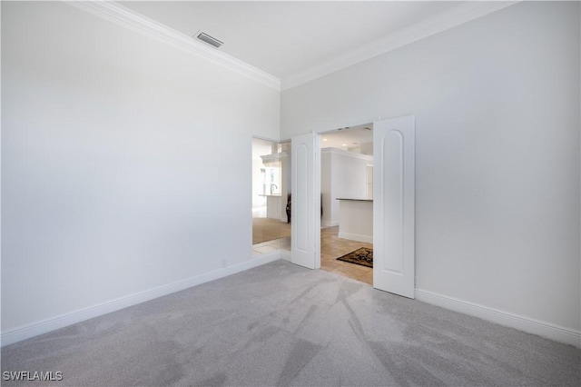 unfurnished bedroom featuring light colored carpet and crown molding