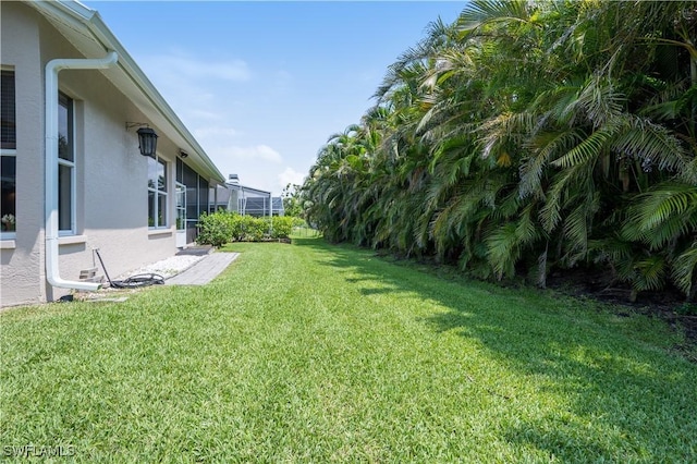 view of yard featuring glass enclosure